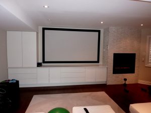 Perforated Projection Screen with Speakers in Behind and Custom Cabinets with Hidden Equipment