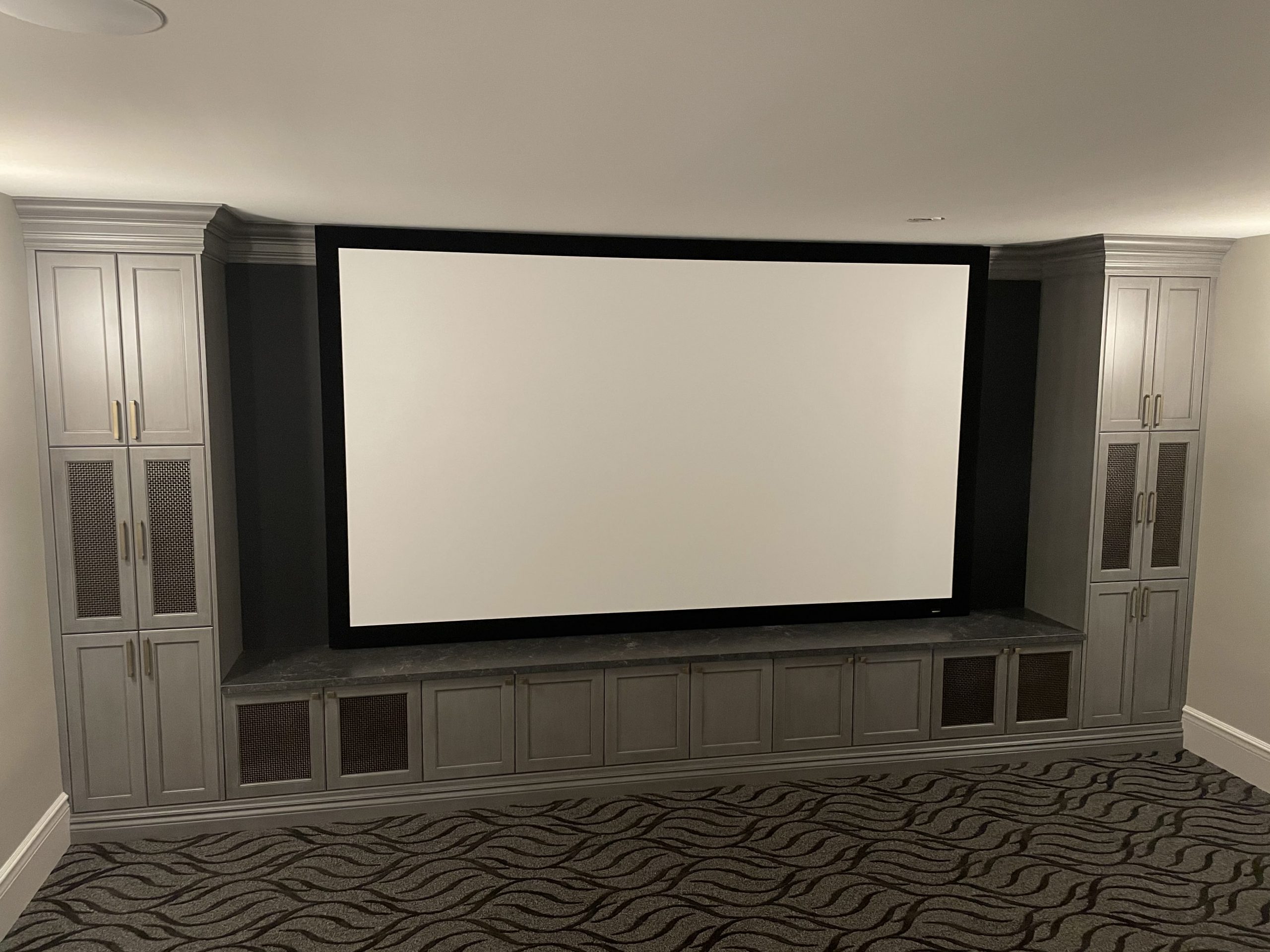 Large Projection Screen Surrounded by Custom Audio Cabinets